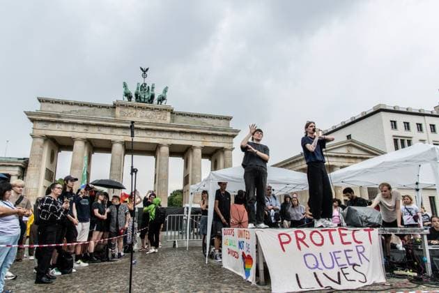 July 26, 2026, Berlin, Germany: BERLIN, GERMANY Ã¢â‚¬ JULY 26, 2026: People attend a vigil at the Brandenburg Gate in Berlin, Germany, following the deadly attack near the city s Christopher Street Day Pride celebrations a day earlier. Mourners laid flowers, candles, signs and LGBTQ+ pride flags in memory of the victims after a vehicle drove into a crowd, killing one person and injuring dozens. German authorities continued searching for the main suspect, identified as Abdul Ballout, whom police said had ties to Islamist extremist circles. Berlin Germany - ZUMAq101 20260726_zna_q101_113 Copyright: xAndro SxTrujillox