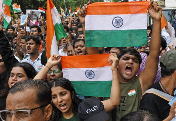 Celebrations after the resignation of Union Education Minister Dharmendra Pradhan in Mumbai, India - 26 Jul 2026 A citizen seen holding a placard and others holding Indian national flags during the celebration held after the resignation of Union Education Minister Dharmendra Pradhan. Youth led Cockroach Janata Party (CJP) protest which lasted for 36 days concluded on July 25 2026 after the government accepted the key demands put forth by leaders of Cockroach Janata Party (CJP) alongside resignation of Union Education Minister Dharmendra Pradhan in alleged paper leaks and irregularities found in major national medical entrance examinations. Mumbai India Copyright: xAshishxVaishnavx xSOPAxImagesx AVaishnav_Celebration after resignation of Union Education Minister Dharmendra Pradhan in Mumbai(6)