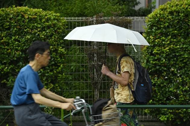 Sudden summer thunderstorm interrupts relief from Tokyo heat TOKYO, JAPAN - JULY 26 : Pedestrians carrying umbrellas walk through a residential neighborhood in Tokyo, Japan, on July 26, 2026, as unstable weather accompanies the intense summer heat. The Japan Meteorological Agency issued a thunderstorm advisory for parts of Tokyo. David Mareuil Anadolu Tokyo Japan. Editorial use only. Please get in touch for any other usage.  Copyright: x2026xAnadoluxDavidxMareuilx