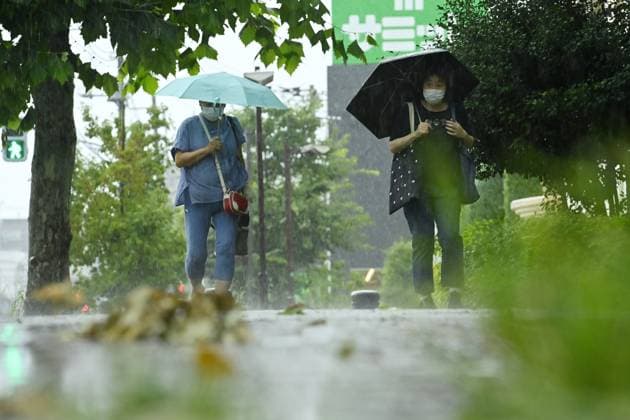 Sudden summer thunderstorm interrupts relief from Tokyo heat TOKYO, JAPAN - JULY 26 : Pedestrians carrying umbrellas walk along a rain-soaked street during a summer thunderstorm in Tokyo, Japan, on July 26, 2026. David Mareuil Anadolu Tokyo Japan. Editorial use only. Please get in touch for any other usage.  Copyright: x2026xAnadoluxDavidxMareuilx