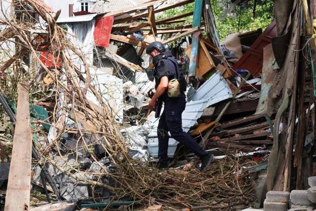 A State Emergency Service rescuer inspects the yard of a private house in the Slobidskyi district, destroyed by a direct hit from a Russian S8000 Banderol cruise missile, Kharkiv, Ukraine, July 26, 2026. A 40-year-old woman was killed in the attack, and 12 people were injured. In total, at least 22 private houses and power lines were damaged in the district. (Photo by Viacheslav Madiievskyi Ukrinform) Russians strike residential area in Kharkiv with Banderol missile  Copyright: xVi8acheslavxMadiievskyix