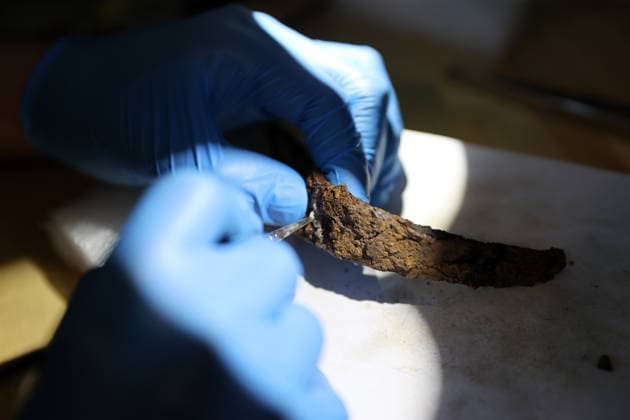 Gold amulet, ancient seal unearthed at Turkmen Karahoyuk excavation in Turkiye s Konya KONYA, TURKIYE - JULY 26: An archaeologist cleans an artifact unearthed during excavations at the Turkmen Karahoyuk archaeological site in the Cumra district of Konya, Turkiye, on July 26, 2026. Archaeologists conducting excavations at the ancient settlement recently uncovered a 3,500-year-old seal inscribed with Luwian hieroglyphs and a gold amulet dating to the Roman period, along with various other artifacts. Serhat Cetinkaya Anadolu Konya Turkey. Editorial use only. Please get in touch for any other usage.  Copyright: x2026xAnadoluxSerhatxCetinkayax