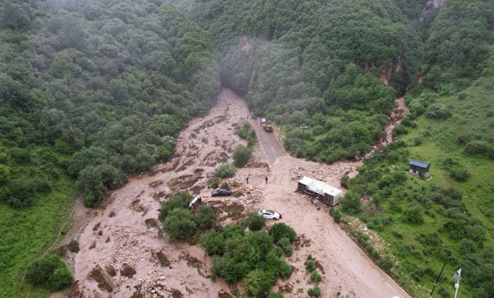 (260727) -- WEIYUAN, July 27, 2026 -- An aerial drone photo taken on July 27, 2026 shows the flood-hit area in Weiyuan County, northwest China s Gansu Province. The flash flood, triggered by sudden heavy rainfall, hit a scenic area in Weiyuan County, Dingxi City, on Sunday afternoon, leaving 10 people dead and 23 injured as of 6 p.m. ? ?Some tourists were camping in the scenic area and were trapped after the flood burst out, local authorities said. ? ?A total of 305 rescue personnel with 68 vehicles from the national comprehensive fire and rescue teams are conducting rescue operations at the site, according to the MEM. ) (SpotNews) CHINA-GANSU-WEIYUAN-FLASH FLOOD-RESCUE AND RELIEF WORK (CN) ChenxBin 