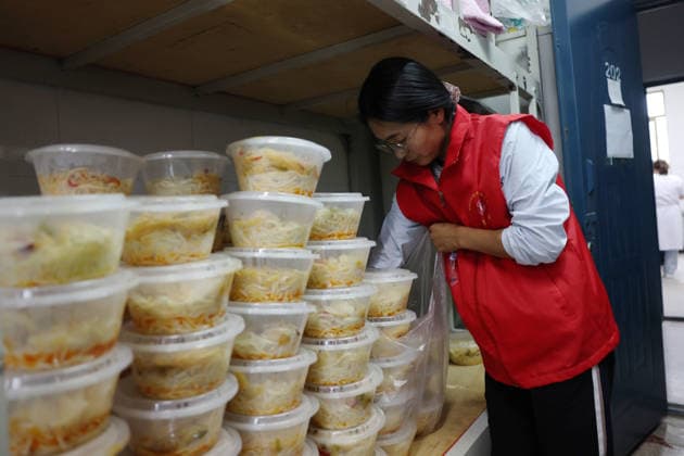 (260727) -- WEIYUAN, July 27, 2026 -- A volunteer prepares food for flood-affected people at a temporary relocation site in Weiyuan County, northwest China s Gansu Province, July 27, 2026. The flash flood, triggered by sudden heavy rainfall, hit a scenic area in Weiyuan County, Dingxi City, on Sunday afternoon, leaving 10 people dead and 23 injured as of 6 p.m. ? ?Some tourists were camping in the scenic area and were trapped after the flood burst out, local authorities said. ? ?A total of 305 rescue personnel with 68 vehicles from the national comprehensive fire and rescue teams are conducting rescue operations at the site, according to the MEM. ) (SpotNews) CHINA-GANSU-WEIYUAN-FLASH FLOOD-RESCUE AND RELIEF WORK (CN) ChenxBin 