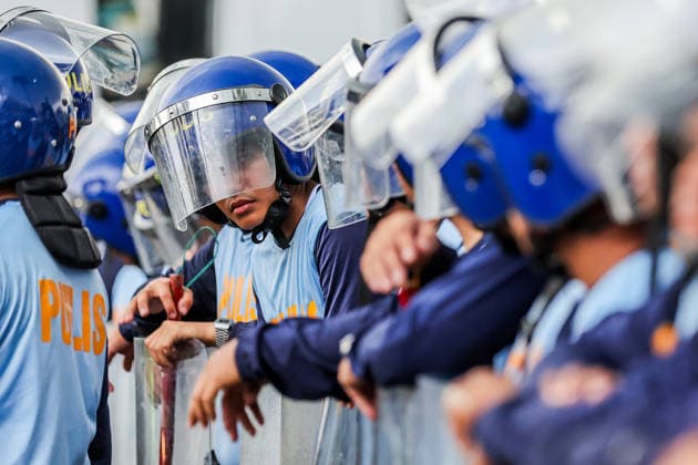 (260727) -- QUEZON CITY, July 27, 2026 -- Police officers from the Philippine National Police gather to block the path of protesters during a rally, as President Ferdinand Romualdez Marcos Jr. delivers his 5th State of the Nation Address (SONA) at the House of Representatives, in Quezon City, the Philippines, on July 27, 2026. Various sectors took to the streets to voice their grievances over government policies. ) THE PHILIPPINES-QUEZON CITY-STATE OF THE NATION ADDRESS-PROTEST RouellexUmali 