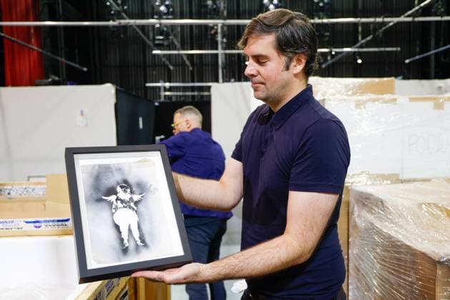 July 27, 2026, Tampa, Florida, USA: Fraser Goulding, an art installer, shows a stencil which was used to create an art piece from street artist, Banksy, at the Straz Center on Monday, July 27, 2026, in Tampa. Tampa USA  - ZUMAs70_ 20260727_zan_s70_018 Copyright: xJeffereexWoox