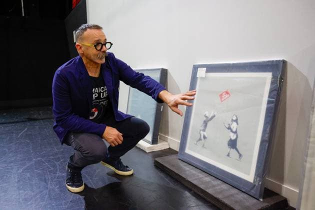 July 27, 2026, Tampa, Florida, USA: Richard Wormley, an assistant curator, speaks about artworks by street artist, Banksy, at the Straz Center on Monday, July 27, 2026, in Tampa. Tampa USA - ZUMAs70_ 20260727_zan_s70_012 Copyright: xJeffereexWoox