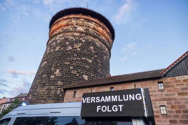 Montagsdemo Team Menschenrechte mit Gegendemonstration und Blockaden, Nürnberg, 27.07.2026 Eine digitale Anzeigetafel mit der Aufschrift Versammlung folgt steht vor einem historischen Wehrturm. Im Vordergrund ist ein Fahrzeug der Einsatzkräfte zu sehen, im Hintergrund erhebt sich der Spittlertorturm in der Abenddämmerung. Nürnberg Bayern Deutschland *** Monday Demonstration: Human Rights Team with a counter-demonstration and blockades, Nuremberg, July 27, 2026 A digital display board reading Gathering to follow stands in front of a historic defensive tower. In the foreground is a law enforcement vehicle; in the background, the Spittlertorturm rises against the twilight sky. Nuremberg, Bavaria, Germany 20260727-286A3143-M4000