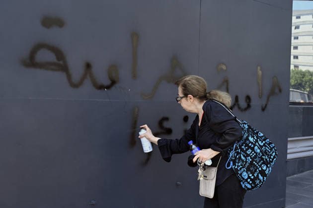 Depositors protest frozen savings at banks in Lebanon BEIRUT, LEBANON - JULY 28: A woman writes thives in Arabic with a spray as people, who are unable to withdraw their money after all foreign currency deposit accounts in the country were frozen in 2019 to prevent the depletion of foreign exchange reserves, stage a protest in Beirut, Lebanon on July 28, 2026. Houssam Shbaro Anadolu Beirut Lebanon. Editorial use only. Please get in touch for any other usage.  Copyright: x2026xAnadoluxHoussamxShbarox