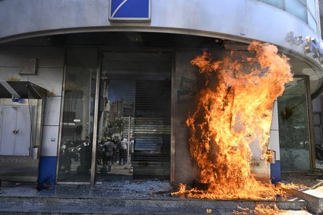 Depositors protest frozen savings at banks in Lebanon BEIRUT, LEBANON - JULY 28: Protesters light fires in front of a bank as people, who are unable to withdraw their money after all foreign currency deposit accounts in the country were frozen in 2019 to prevent the depletion of foreign exchange reserves, stage a protest in Beirut, Lebanon on July 28, 2026. Houssam Shbaro Anadolu Beirut Lebanon. Editorial use only. Please get in touch for any other usage.  Copyright: x2026xAnadoluxHoussamxShbarox