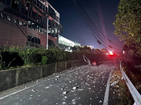 Strong quake jolts southwestern Japan Photo taken on July 28, 2026, shows a destroyed Aeon Mall building (L) in Kashima, Kumamoto Prefecture, following an explosion after a magnitude 7.1 earthquake shook the southwestern Japan prefecture. Many people are feared trapped inside the building.  A14AA0005624340P