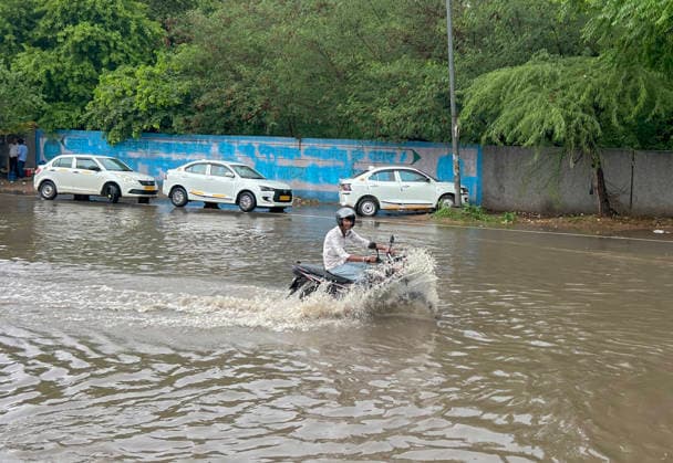 GURUGRAM, INDIA - JULY 28: Vehicles wade through the waterlogged stretch at NH-48 service road near sector 15 on July 28, 2026 in Gurugram, India. (Photo by Parveen Kumar Hindustan Times) Heavy Rains Inundates Gurugram