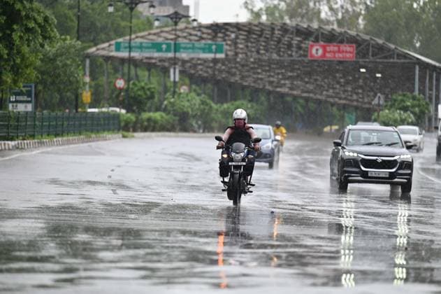 GURUGRAM, INDIA - JULY 28: Commuters make their way through rain showers on Sheetla Mata Road near Sukhrali Chowk on July 28, 2026 in Gurugram, India. (Photo by Parveen Kumar Hindustan Times) Heavy Rains Inundates Gurugram
