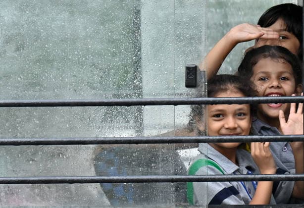GURUGRAM, INDIA - JULY 28: Children are seen enjoying the rain showers on Sheetla Mata Road near Sukhrali Chowk on July 28, 2026 in Gurugram, India. (Photo by Parveen Kumar Hindustan Times) Heavy Rains Inundates Gurugram