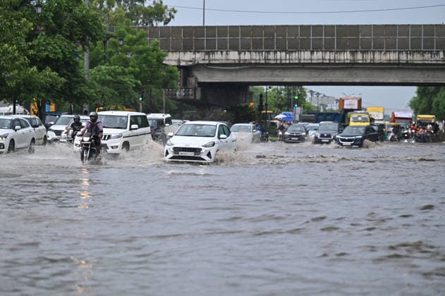 GURUGRAM, INDIA - JULY 28: Vehicles wade through a waterlogged stretch during rain on the sector-14 17 dividing road near MDI Chowk on July 28, 2026 in Gurugram, India. (Photo by Parveen Kumar Hindustan Times) Heavy Rains Inundates Gurugram