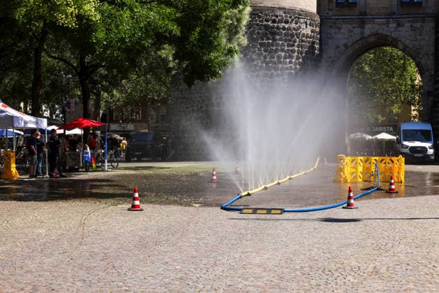 Cologne unveils cooling mist initiative as heatwave grips Germany COLOGNE, GERMANY - JULY 29: People try to cool off at Rudolfplatz Square during the Cooling Cologne initiative, where chilled groundwater was dispersed through fine mist sprays connected to fire hoses in Cologne, Germany on July 29, 2026. Organizers said the system lowered the surrounding temperature by about 12 degrees Celsius, offering relief as a heatwave swept across the region. Kadir Ilboga Anadolu Cologne Germany. Editorial use only. Please get in touch for any other usage.  Copyright: x2026xAnadoluxKadirxIlbogax