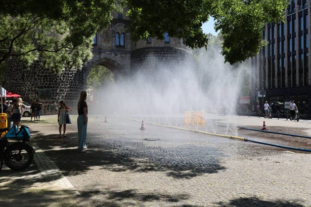 Cologne unveils cooling mist initiative as heatwave grips Germany COLOGNE, GERMANY - JULY 29: People try to cool off at Rudolfplatz Square during the Cooling Cologne initiative, where chilled groundwater was dispersed through fine mist sprays connected to fire hoses in Cologne, Germany on July 29, 2026. Organizers said the system lowered the surrounding temperature by about 12 degrees Celsius, offering relief as a heatwave swept across the region. Kadir Ilboga Anadolu Cologne Germany. Editorial use only. Please get in touch for any other usage.  Copyright: x2026xAnadoluxKadirxIlbogax