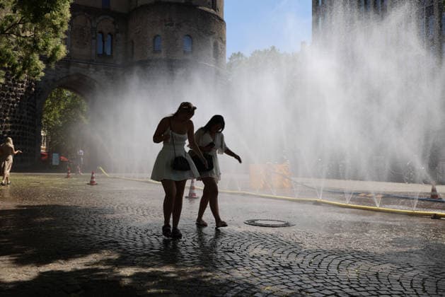 Cologne unveils cooling mist initiative as heatwave grips Germany COLOGNE, GERMANY - JULY 29: People try to cool off at Rudolfplatz Square during the Cooling Cologne initiative, where chilled groundwater was dispersed through fine mist sprays connected to fire hoses in Cologne, Germany on July 29, 2026. Organizers said the system lowered the surrounding temperature by about 12 degrees Celsius, offering relief as a heatwave swept across the region. Kadir Ilboga Anadolu Cologne Germany. Editorial use only. Please get in touch for any other usage.  Copyright: x2026xAnadoluxKadirxIlbogax