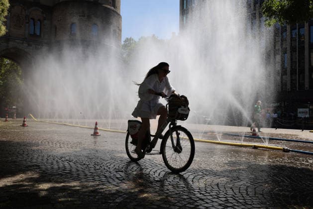 Cologne unveils cooling mist initiative as heatwave grips Germany COLOGNE, GERMANY - JULY 29: People try to cool off at Rudolfplatz Square during the Cooling Cologne initiative, where chilled groundwater was dispersed through fine mist sprays connected to fire hoses in Cologne, Germany on July 29, 2026. Organizers said the system lowered the surrounding temperature by about 12 degrees Celsius, offering relief as a heatwave swept across the region. Kadir Ilboga Anadolu Cologne Germany. Editorial use only. Please get in touch for any other usage.  Copyright: x2026xAnadoluxKadirxIlbogax