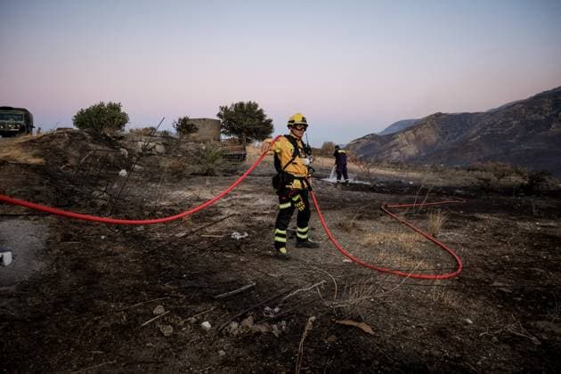 (260730) -- CRETE, July 30, 2026 -- Firefighters take part in firefighting operations in Rethymno on the island of Crete, Greece, July 29, 2026. Two firefighters lost their lives while battling a fast-moving wildfire in Rethymno on the Greek island of Crete on Wednesday, as gale-force winds fueled the blaze across a front stretching more than 15 kilometers. (Photo by Xinhua) GREECE-CRETE-WILDFIRE-FIREFIGHTERS RapanisxSpiros 