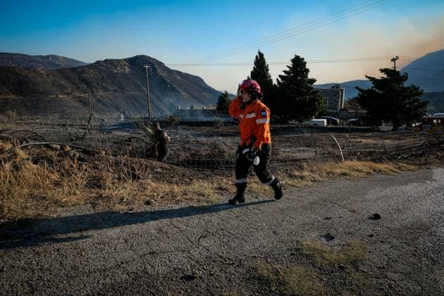 (260730) -- CRETE, July 30, 2026 -- A firefighter takes part in firefighting operations in Rethymno on the island of Crete, Greece, July 29, 2026. Two firefighters lost their lives while battling a fast-moving wildfire in Rethymno on the Greek island of Crete on Wednesday, as gale-force winds fueled the blaze across a front stretching more than 15 kilometers. (Photo by Xinhua) GREECE-CRETE-WILDFIRE-FIREFIGHTERS RapanisxSpiros 