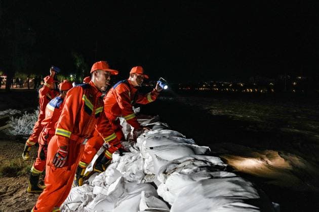 (260730) -- DUNHUANG, July 30, 2026 -- Rescuers monitor water conditions along the Danghe River in Dunhuang, northwest China s Gansu Province, July 29, 2026. The water level of the Danghe River, which runs through Dunhuang City in northwest China s Gansu Province, rose rapidly following days of heavy rainfall and increased inflows from upstream. Local personnel in Dunhuang quickly mobilized for flood control and relief operations. ) CHINA-GANSU-DUNHUANG-FLOOD CONTROL (CN) LangxBingbing 