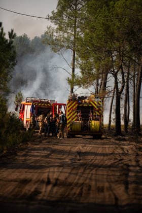 Wildfire Near Le Temple - Gironde Firefighters gather beside two fire engines on a forest road during wildfire suppression operations near Le Temple, Gironde, southwestern France, on July 29, 2026. Smoke rises through the pine forest as crews prepare to continue containing the wildfire.  Copyright: xSaptexFabrice ABACAx