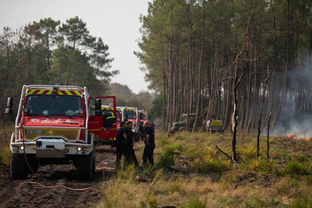 Wildfire Near Le Temple - Gironde Firefighters stand beside several fire engines on a forest road during wildfire suppression operations near Le Temple, Gironde, southwestern France, on July 29, 2026. Burned vegetation surrounds the area as crews continue working to contain the wildfire.  Copyright: xSaptexFabrice ABACAx