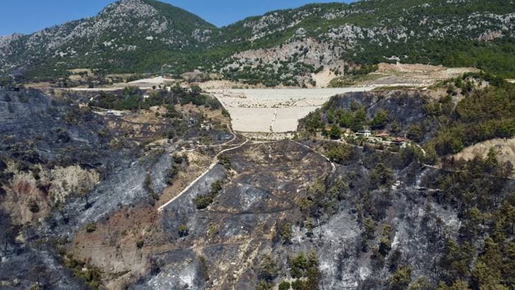 Aerial ciew reveals wildfire damage in Kumluca, Antalya ANTALYA, TURKIYE - JULY 30: An aerial view shows forested areas and buildings damaged by a wildfire that was brought under control in the Kumluca district of Antalya, on July 30, 2026 in Antalya, Turkiye. The fire left large areas of vegetation scorched and caused damage to properties in the affected region. Kasim Sakalli Anadolu Antalya Turkey. Editorial use only. Please get in touch for any other usage.  Copyright: x2026xAnadoluxKasimxSakallix