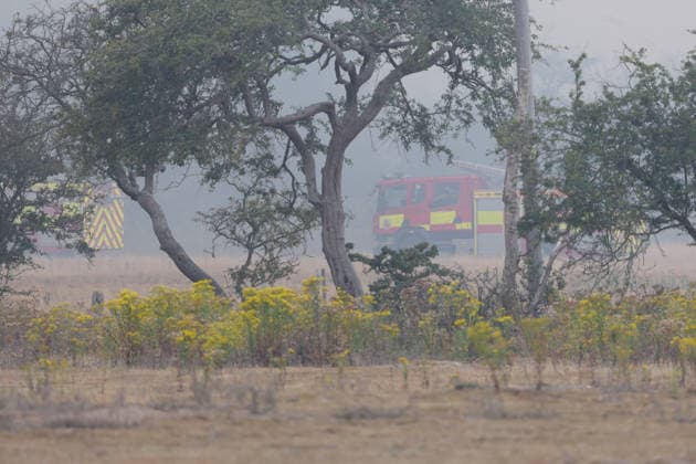 July 30, 2026, Dunwich Heath, Suffolk, UK: Dunwich Heath, UK. A fire engine, surrounded by smoke at the scene of a large wildfire in Dunwich, Suffolk. The fire began on Wednesday afternoon and has been declared a major incident. Up to 90 firefighters have been tackling the blaze. Dunwich Heath UK  - ZUMAl94_ 20260730_zaf_l94_059 Copyright: xJacquelinexLawriex