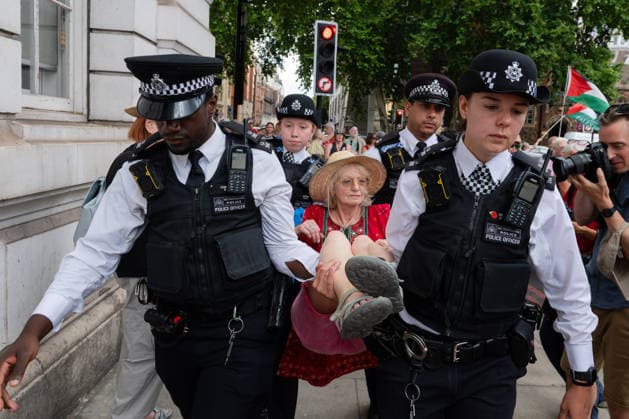 July 30, 2026, London, England, United Kingdom: Metropolitan Police officers arrest a protester during a demonstration outside Westminster Magistrates Court in central London on July 30, 2026. The protest, organised by Defend Our Juries, opposed the proscription of Palestine Action and the use of terrorism legislation against demonstrators. London United Kingdom - ZUMAk172 20260730_zip_k172_027 Copyright: xThomasxKrychx