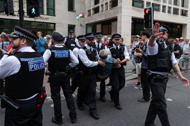 July 30, 2026, London, England, United Kingdom: Metropolitan Police officers arrest a protester during a demonstration outside Westminster Magistrates Court in central London on July 30, 2026. The protest, organised by Defend Our Juries, opposed the proscription of Palestine Action and the use of terrorism legislation against demonstrators. London United Kingdom  - ZUMAk172 20260730_zip_k172_028 Copyright: xThomasxKrychx