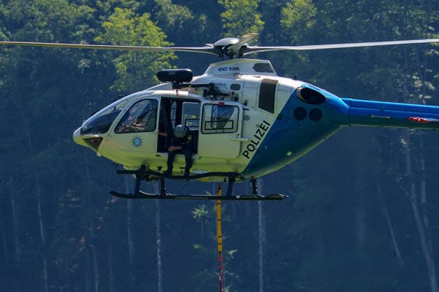 Firefighters battle mountain wildfire near Oberwössen in Bavaria. Germany - Oberwössen, 30.07.2026 Filling up the Bambi bucket as firefighters battle a mountain wildfire above Oberwössen in the Traunstein district of Bavaria on Thursday. Ground crews, supported by police helicopters carrying out bambi buckets, work to contain the blaze in steep and difficult-to-access terrain. Bavaria