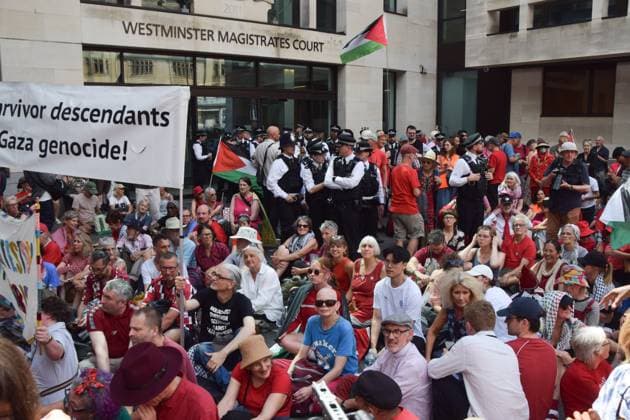 Defend Our Juries Protest in London, UK - 30 July 2026 Protesters sit outside the court during the demonstration. Protesters gathered outside Westminster Magistrates Court during the so-called Graduation Day demonstration organised by Defend Our Juries against the ban on the activist group Palestine Action. London United Kingdom Copyright: xVukxValcicx xSOPAxImagesx Vuk-Valcic-1440469