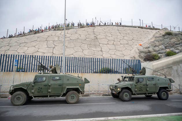 Ceuta wakes up to a steady stream of people from Morocco and thousands of young people wandering the streets. Army vehicles patrol the border, July 31, 2026, in Ceuta, Spain. The autonomous city of Ceuta awoke to a steady stream of people continuing to enter from Morocco early this morning, following a night in which the influx through the border area never ceased. Thousands of migrants have entered the autonomous city today by swimming and also on on foot, skirting the breakwater that separates the autonomous city from Morocco. Police sources indicate that more than 20,000 people have entered Spain. JULY 31, 2026 Ceuta, Spain  Copyright: xMarcosxMorenox 7696250