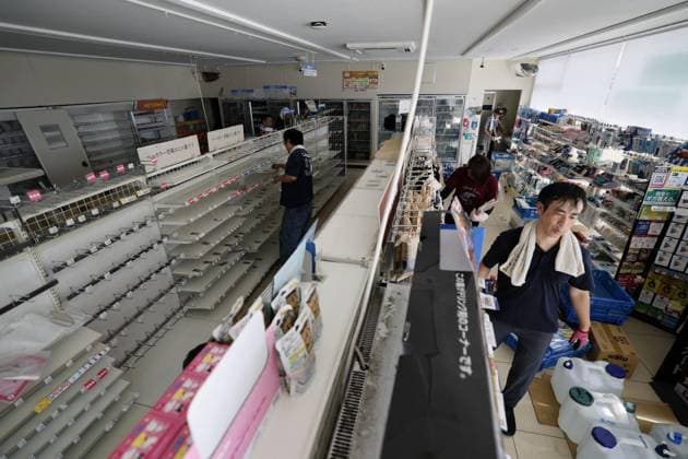 Aftermath of strong earthquake in Kumamoto Staff members on July 31, 2026, clean up a Lawson convenience store in Uki in Kumamoto Prefecture, southwestern Japan, after a powerful earthquake struck the region three days earlier.  A14AA0005624719P