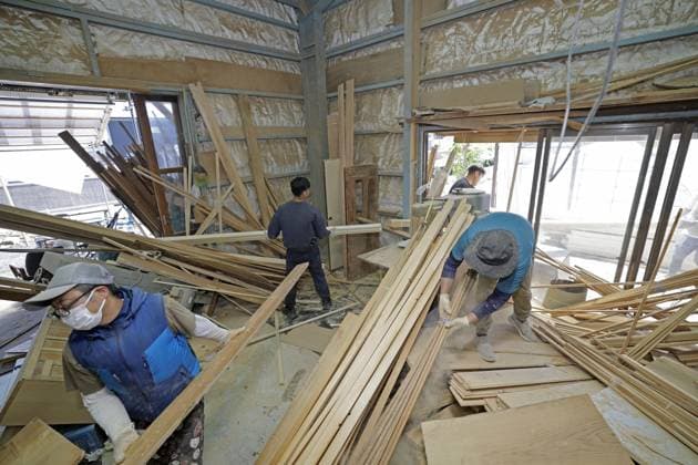 Aftermath of strong earthquake in Kumamoto Workers on July 31, 2026, clean up a carpentry shop in Hikawa in Kumamoto Prefecture, southwestern Japan, after a powerful earthquake hit the region three days earlier.  A14AA0005624720P