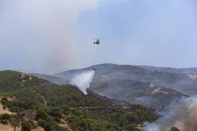 Firefighting efforts continue in Aydin AYDIN, TURKIYE - JULY 31: A firefighting helicopter drops water over a forested area as aerial and ground crews continue battling a wildfire in the Cine district of Aydin, on July 31, 2026 in Aydin, Turkiye. Yusuf Konrat Anadolu Aydin Turkey. Editorial use only. Please get in touch for any other usage.  Copyright: x2026xAnadoluxYusufxKonratx