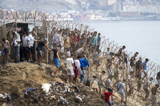 Spain says over 48,300 migrants have returned to Morocco from Ceuta CEUTA, SPAIN - JULY 31: Undocumented migrants, mostly young men, who entered Spain s North African enclave of Ceuta illegally, begin returning to Morocco after realizing their chances of obtaining legal status in Spain are unlikely on July 31, 2026. Meanwhile, small groups of migrants continue trying to cross into Ceuta by swimming or climbing the breakwater surrounding the Fnideq coast. More than 48,300 of the approximately 50,000 migrants who entered the Spanish enclave of Ceuta since early Thursday have returned to Morocco by Friday afternoon, Spain s Interior Ministry said, according to EFE news agency. Abu Adem Muhammed Anadolu Ceuta Spain. Editorial use only. Please  Copyright: x2026xAnadoluxAbuxAdemxMuhammedx