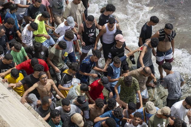 Spain says over 48,300 migrants have returned to Morocco from Ceuta CEUTA, SPAIN - JULY 31: Undocumented migrants, mostly young men, who entered Spain s North African enclave of Ceuta illegally, begin returning to Morocco after realizing their chances of obtaining legal status in Spain are unlikely on July 31, 2026. Meanwhile, small groups of migrants continue trying to cross into Ceuta by swimming or climbing the breakwater surrounding the Fnideq coast. More than 48,300 of the approximately 50,000 migrants who entered the Spanish enclave of Ceuta since early Thursday have returned to Morocco by Friday afternoon, Spain s Interior Ministry said, according to EFE news agency. Abu Adem Muhammed Anadolu Ceuta Spain. Editorial use only. Please  Copyright: x2026xAnadoluxAbuxAdemxMuhammedx