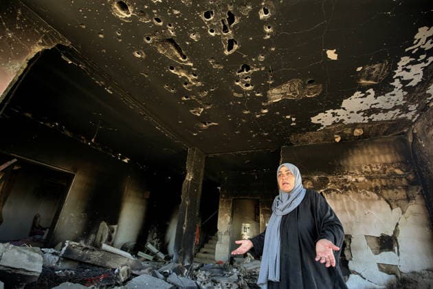 July 31, 2026, Zawtar Al-Gharbieh, Zawtar Al-Gharbieh, Lebanon: Lebanese Ihsan Yaghi, gestures as she stands inside her destroyed and burned house in the southern Lebanese village of Zawatar al-Gharbieh. Civilians started returning slowly the devastated hamlet after the army deployed inside the village following an Israeli withdrawal from several points inside it. Zawtar Al-Gharbieh Lebanon  - ZUMAn313 20260731_zip_n313_016 Copyright: xMarwanxNaamanix