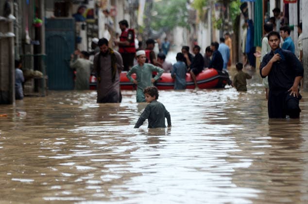 July 31, 2026, Peshawar, Peshawar, Pakistan: Residents wade through flooded street as monsoon rains inundate Peshawar..People wade through a flooded street during heavy monsoon rain in Peshawar, Khyber Pakhtunkhwa province, Pakistan, on July 31, 2026. Pakistan s Meteorological Department (PMD) forecast the current monsoon spell to continue until August 5, warning of widespread rain, thunderstorms, heavy to very heavy downpours, and the risk of urban flooding, flash floods, landslides and river flooding across parts of the country. Peshawar Pakistan  - ZUMAa217 20260731_znp_a217_009 Copyright: xHussainxAlix