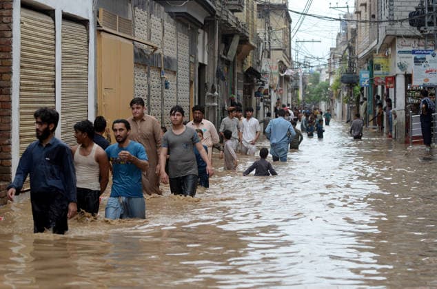 July 31, 2026, Peshawar, Peshawar, Pakistan: Residents wade through flooded street as monsoon rains inundate Peshawar..People wade through a flooded street during heavy monsoon rain in Peshawar, Khyber Pakhtunkhwa province, Pakistan, on July 31, 2026. Pakistan s Meteorological Department (PMD) forecast the current monsoon spell to continue until August 5, warning of widespread rain, thunderstorms, heavy to very heavy downpours, and the risk of urban flooding, flash floods, landslides and river flooding across parts of the country. Peshawar Pakistan  - ZUMAa217 20260731_znp_a217_012 Copyright: xHussainxAlix