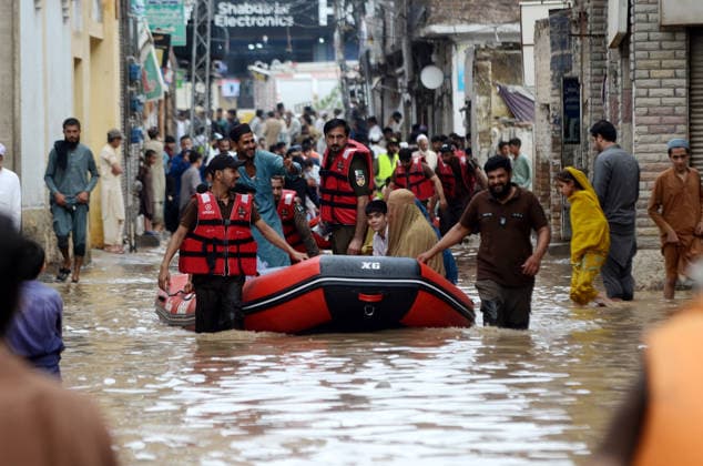 July 31, 2026, Peshawar, Peshawar, Pakistan: Residents wade through flooded street as monsoon rains inundate Peshawar..People wade through a flooded street during heavy monsoon rain in Peshawar, Khyber Pakhtunkhwa province, Pakistan, on July 31, 2026. Pakistan s Meteorological Department (PMD) forecast the current monsoon spell to continue until August 5, warning of widespread rain, thunderstorms, heavy to very heavy downpours, and the risk of urban flooding, flash floods, landslides and river flooding across parts of the country. Peshawar Pakistan  - ZUMAa217 20260731_znp_a217_013 Copyright: xHussainxAlix