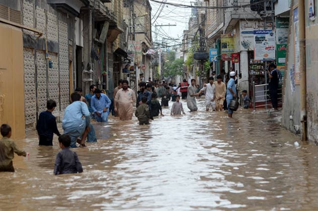 July 31, 2026, Peshawar, Peshawar, Pakistan: Residents wade through flooded street as monsoon rains inundate Peshawar..People wade through a flooded street during heavy monsoon rain in Peshawar, Khyber Pakhtunkhwa province, Pakistan, on July 31, 2026. Pakistan s Meteorological Department (PMD) forecast the current monsoon spell to continue until August 5, warning of widespread rain, thunderstorms, heavy to very heavy downpours, and the risk of urban flooding, flash floods, landslides and river flooding across parts of the country. Peshawar Pakistan - ZUMAa217 20260731_znp_a217_014 Copyright: xHussainxAlix