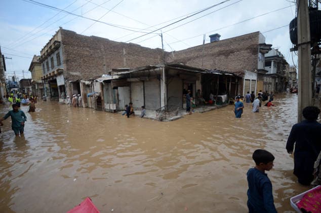 July 31, 2026, Peshawar, Peshawar, Pakistan: Residents wade through flooded street as monsoon rains inundate Peshawar..People wade through a flooded street during heavy monsoon rain in Peshawar, Khyber Pakhtunkhwa province, Pakistan, on July 31, 2026. Pakistan s Meteorological Department (PMD) forecast the current monsoon spell to continue until August 5, warning of widespread rain, thunderstorms, heavy to very heavy downpours, and the risk of urban flooding, flash floods, landslides and river flooding across parts of the country. Peshawar Pakistan  - ZUMAa217 20260731_znp_a217_030 Copyright: xHussainxAlix