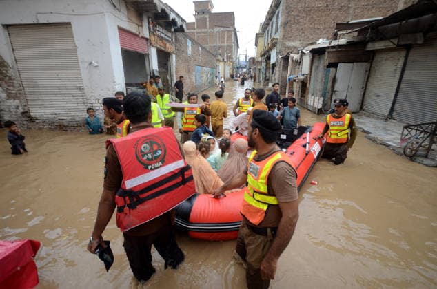 July 31, 2026, Peshawar, Peshawar, Pakistan: Residents wade through flooded street as monsoon rains inundate Peshawar..People wade through a flooded street during heavy monsoon rain in Peshawar, Khyber Pakhtunkhwa province, Pakistan, on July 31, 2026. Pakistan s Meteorological Department (PMD) forecast the current monsoon spell to continue until August 5, warning of widespread rain, thunderstorms, heavy to very heavy downpours, and the risk of urban flooding, flash floods, landslides and river flooding across parts of the country. Peshawar Pakistan - ZUMAa217 20260731_znp_a217_035 Copyright: xHussainxAlix