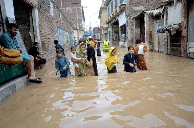 July 31, 2026, Peshawar, Peshawar, Pakistan: People wade through a flooded street during heavy monsoon rain in Peshawar, Khyber Pakhtunkhwa province, Pakistan. Pakistan s Meteorological Department (PMD) forecast the current monsoon spell to continue until August 5, warning of widespread rain, thunderstorms, heavy to very heavy downpours, and the risk of urban flooding, flash floods, landslides and river flooding across parts of the country. Peshawar Pakistan - ZUMAa217 20260731_znp_a217_031 Copyright: xHussainxAlix