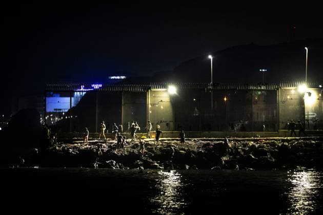 August 1, 2026, Ceuta, Spain: CEUTA, SPAIN - AUGUST 1, 2026: The arrival of migrants across the Tarajal border continues during the early hours of Saturday morning in Ceuta. Authorities maintain security and monitoring devices at the border crossing amid the ongoing influx. Ceuta Spain - ZUMAq101 20260801_zna_q101_055 Copyright: xSamuelxVegax