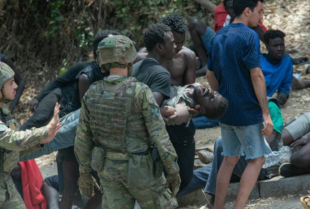 August 1, 2026, Ceuta, Ceuta, Spain: Red Cross members attend to migrants near the Temporary Stay Centre for Immigrants Ceuta Spain - ZUMAd308 20260801_zsp_d308_067 Copyright: xJuanxCarlosxLucasx